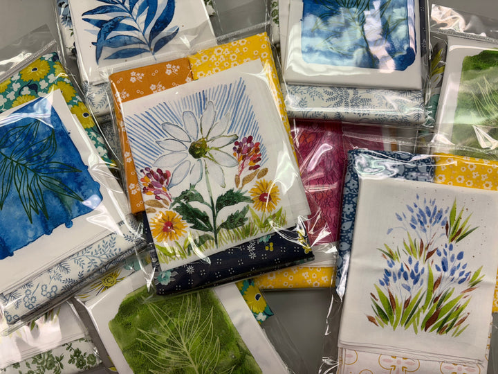 Collection of floral and nature-themed greeting cards in packaging